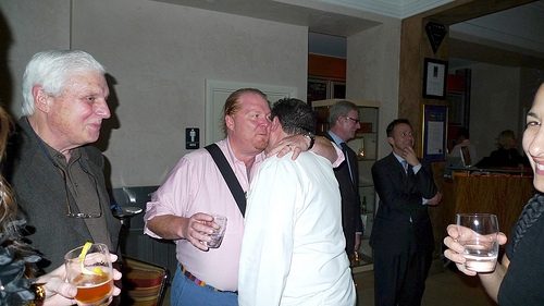 When Chef Mario Batali arrived for dinner, Chef Emeril came out of the kitchen to greet him at the bar. That's my sazarac you see in the lower left corner!

Tune in today at 2 pm ET/11 am PT to hear Chef Emeril and Chef Mario talk tailgate foods, football, and lots more. They're live and taking your calls along with chefs representing the Colts and the Saints, Chef Douglas Rodriguez from Miami, Super Bowl Gospel Celebration headliners BeBe and CeCe Winans, and 