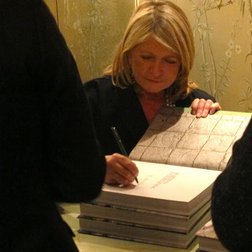 Martha personalizes a book (or three) with her John Hancock.