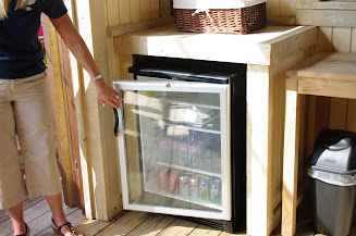 A stocked refrigerator inside the cabana.  Waters and sodas are available cold.