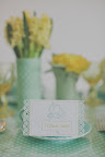 A place card with a decorative edge compliments the vases and textures of the flowers.