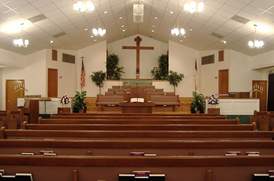 c0 A not untypical Baptist sanctuary; this one happens to be Westside Baptist Church in Hinesville, Georgia; I've never been there. In this case, the baptistery is elevated and beneath the cross in the center of the picture.