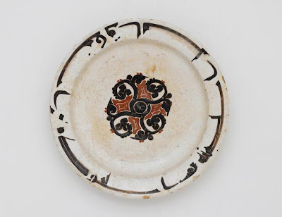 Dish | Origin:  Iran or Afghanistan | Period: 10th century  Samanid period | Details:  Among the most distinct and impressive examples of Persian ceramics are a group produced during the reign of the Samanids (819-1005) in Khurasan in northeastern Iran, present-day Afghanistan, and Uzbekistan. These vessels are embellished with inscriptions, usually in the form of a moralizing proverb. The inscription on this small plate reads, Excellence if the quality of the people of paradise. | Type: Earthenware painted under glaze | Size: H: 3.6  W: 21.0  cm | Museum Code: F1965.27 | Photograph and description taken from Freer and the Sackler (Smithsonian) Museums.