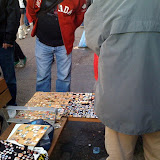 Rogue pin traders are set up all along the streets. Rogue pin traders are set up all along the streets.