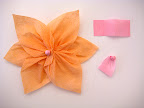 Stack twisted pieces on top of each other, staggering each layer. Secure with glue. 
Roll rectangle pieces into small balls and glue to the center of your flower.