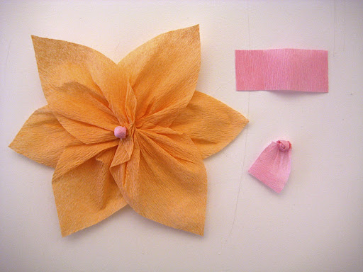 Stack twisted pieces on top of each other, staggering each layer. Secure with glue. 
Roll rectangle pieces into small balls and glue to the center of your flower.