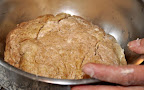 She then transfers the dough to an oiled bowl and brushes the top with oil.

Photo by:  Samantha Kuvin