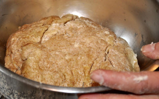 She then transfers the dough to an oiled bowl and brushes the top with oil.

Photo by:  Samantha Kuvin