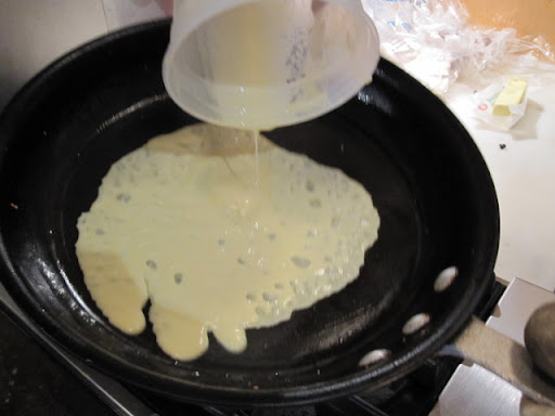 Swirling to coat the bottom of the pan