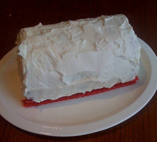 Frost the outside of the cake, and the unfrosted end.  Add whatever decorations you want.
