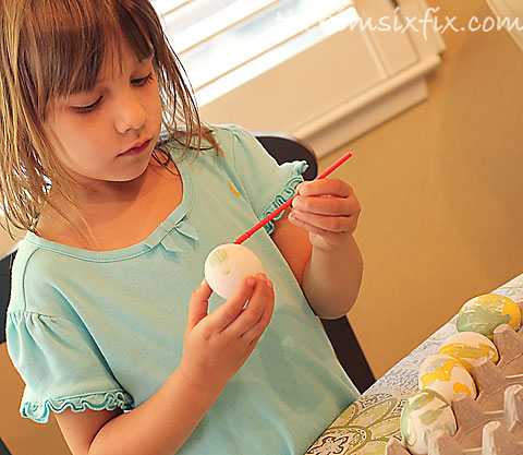 Child painting easter egg