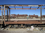Looking at the engines through a row of decaying box cars.