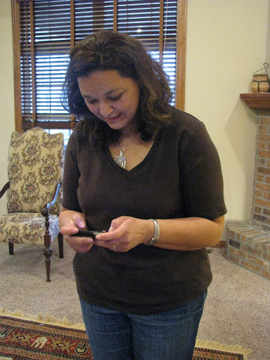 Hala, 41, from Benghazi, Libya, checks her facebook page on her phone in Nixa, Missouri, to see whether her relatives overseas have posted anything in the past few minutes.  (Photo credit:  Jennifer Moore)