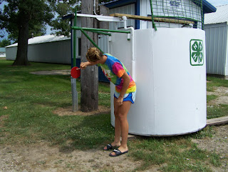 Mackenzie Adrian, 4-H County Council member, finalizes the paint job Thursday afternoon in preparation for Monday’s Dunk Tank grand opening.  Photo Courtesy of the Washington County Extension.