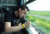 Writing postcards on the train