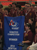 Team poses with banner