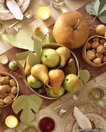 A simple way to create a centerpiece for your Thanksgiving table is using different foods you have gathered around. A large bowl of pears or different nuts is a simple and flavorful arrangment.
