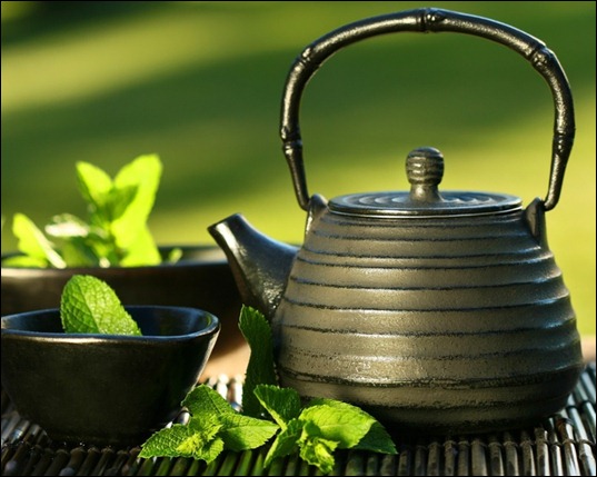 Black asian teapot with mint tea