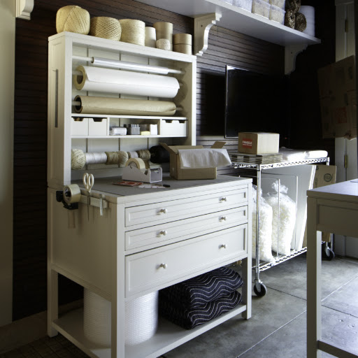 The packing station in the homekeeping room is made from the gift wrap hutch and another three drawer flat file.