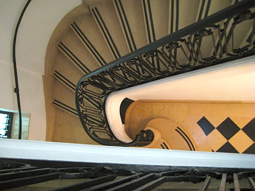 The staircase is marble and spiraling.