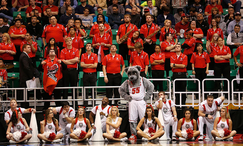 University of New Mexico cheerleaders and band react as the basketball team loses to Harvard in the NCAA tournament