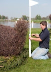 Tom completes the lake Grassroots fence with the flag