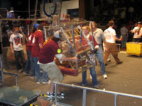 The drive team carrying the robot off after a match