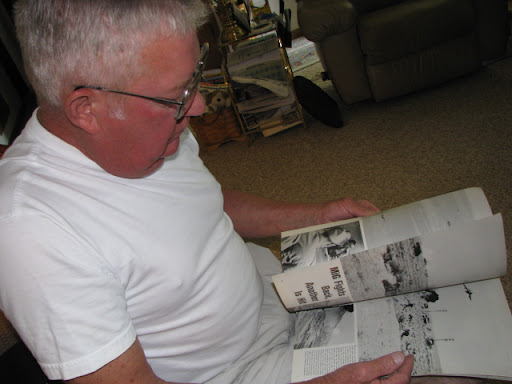 Former Marine and USS Liberty survivor Bryce Lockwood looks though an old news magazine on the Six-Day War.