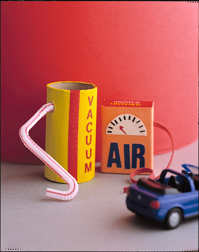 Accessories for our car garage: toilet paper tube vacuum and raisin box air pump.