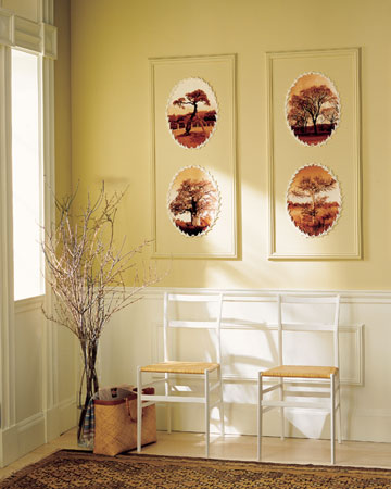 These sepia landscapes are framed by a decorative trim that sticks to surfaces when gently heated. The images and trim are arranged on freestanding panels that were painted to match the walls and then mounted when the artwork was complete.