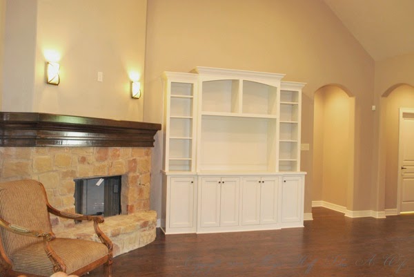 Living room with stone fireplace white built in and wood floors.jpg Living room with stone fireplace white built in and wood floors