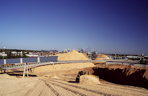 The Producers - A D-8 Caterpillar bulldozer moves slowly up a massive chip pile at Boise Cascade Corporation's International Falls, Minnesota paper mill in this 2000 photograph. At the time, the mill employed more than 1,100 workers and was producing about 1,500 tons of paper daily. Among its customers: Xerox, Staples, IBM, Kinkos and Canon. Minnesota's paper industry has been hit hard by poor market conditions and foreign competition. Boise Cascade is a very different company today. Its timber lands now belong to Forest Capital, a real estate investment trust, and its manufacturing facilities belong to Madison Dearborn, a Chicaogo-based private equity group. The renamed Boise is an office products retailer.