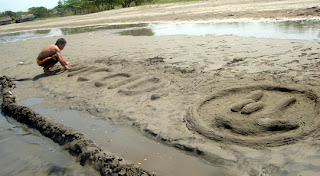 April 19: Ericson carves MCCID I-L-Y sign on sand.