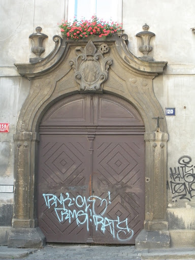 The cool blue of the graffiti mixed with the chocolate of the door and the pop of red flowers is an inspiring combination. I see why Yvette was drawn to it.  (Prague)