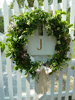 Wreaths decorated the gates to the venue. Each one sported an initial for the bride and groom and a big, floppy bow. Made entirely of greenery, the only colored accent was pink jasmine.