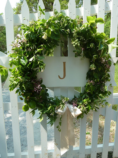 Wreaths decorated the gates to the venue. Each one sported an initial for the bride and groom and a big, floppy bow. Made entirely of greenery, the only colored accent was pink jasmine.