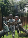 Children Reading On a Log