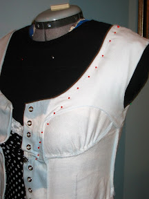 I put red pins along the edge of the elastic to show where it goes. The facing is tacked to the dress in a couple spots to keep the elastic contained.