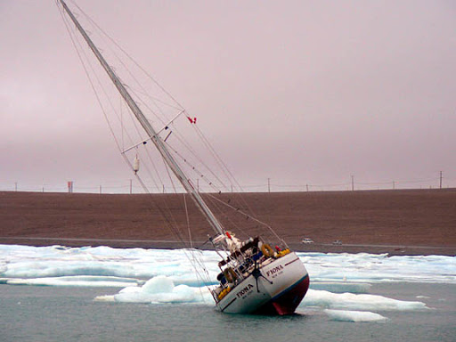 Northwest Passage boat, Fiona driven to ground by ice in Resolute Bay. Image courtesy of Russ Roberts/ yachtfiona.com