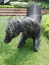 Black kneeling sculptural horse