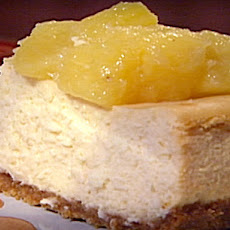 Golden Pineapple Cheesecake with Guava Coulis and Candied Ginger