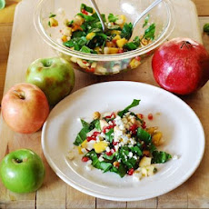 Chopped salad with apples, pears, mango, spinach, hazelnuts, and pomegranates