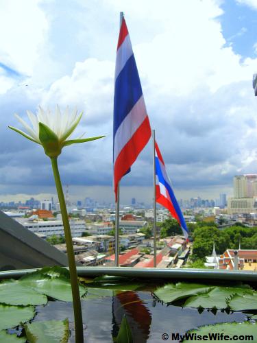White lotus, Thai flag and skyline of Bangkok