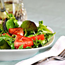 A Salad of Arugula (Rocket), Cherry Tomatoes and Sesame Seed