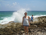 Picture of Katie in front of one of the blow holes splashing.