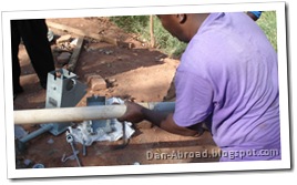 Afridev parts, cementing the cylinder with foot valve (grey piece) to the PVC pipe (white piece).