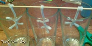 pipecleaner snowflakes hanging in glasses