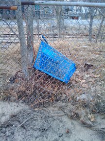 Abandoned Marshalls cart near fence and tracks