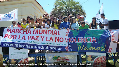 Los atletas posraon para la foto con la bandera de la marcha mundial por la paz y la no violencia