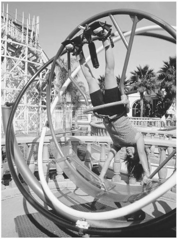 Torque, along with angular momentum, is the leading factor dictating the motion of a gyroscope. Here, a woman rides inside a giant gyroscope at an amusement park. 