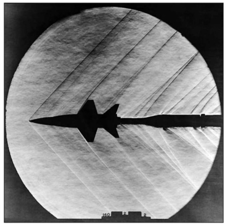 The shock waves caused by supersonic flight can be seen emanating from a model of the X-15 as it flies through a supersonic pressure tunnel. (NASA)